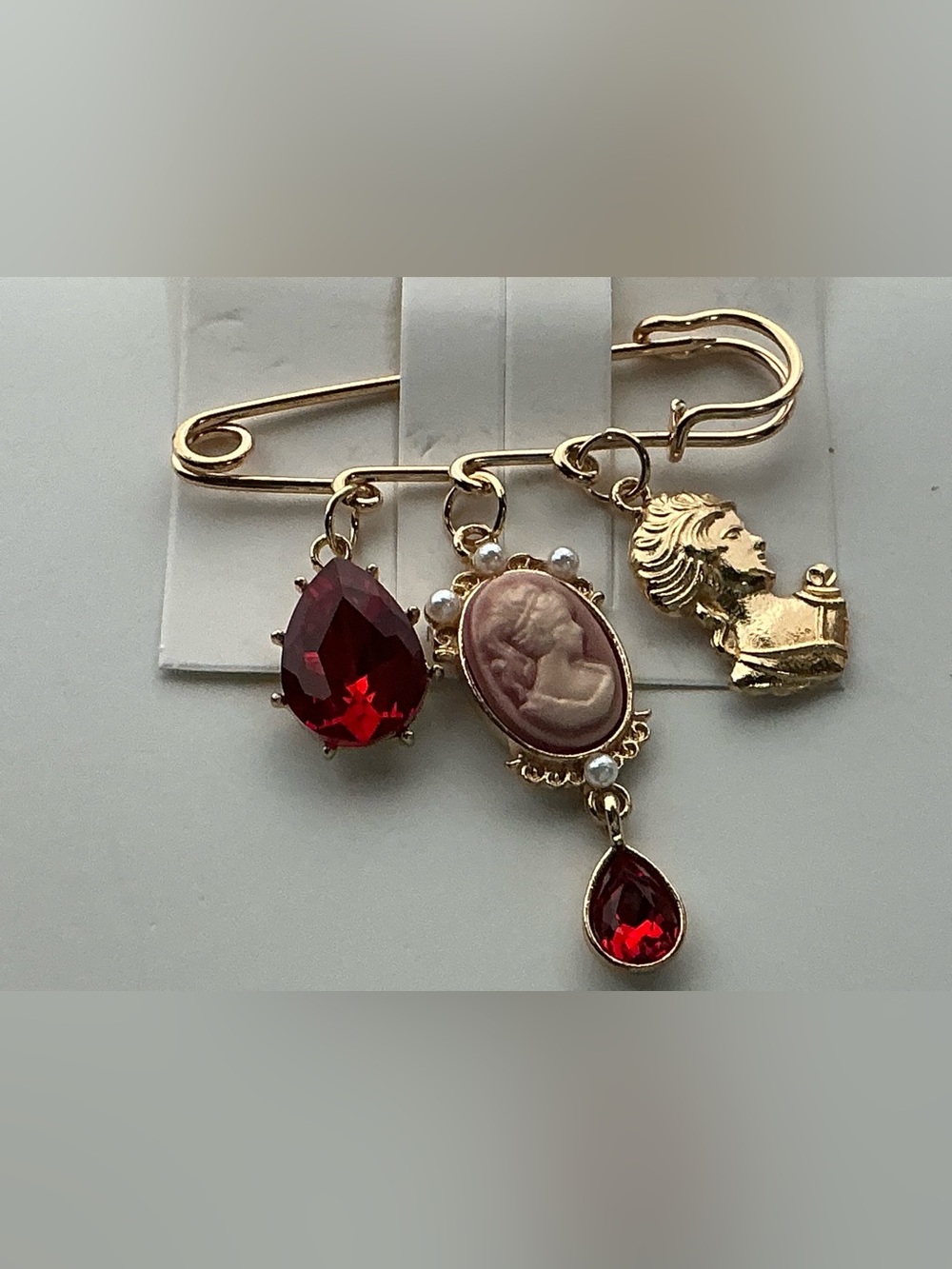 Vintage-Inspired Gold Safety Pin Brooch with Red Gem and Cameo